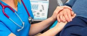 Nurse holding a patient's hand