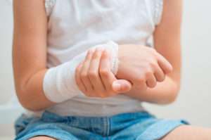 Child's arm with gauze bandage on it